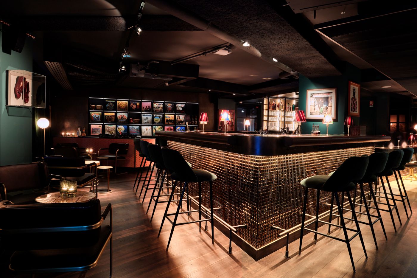 The interior of the Sape Bar, with a DJ booth and several records on the wall as well as a bounter with bar stools